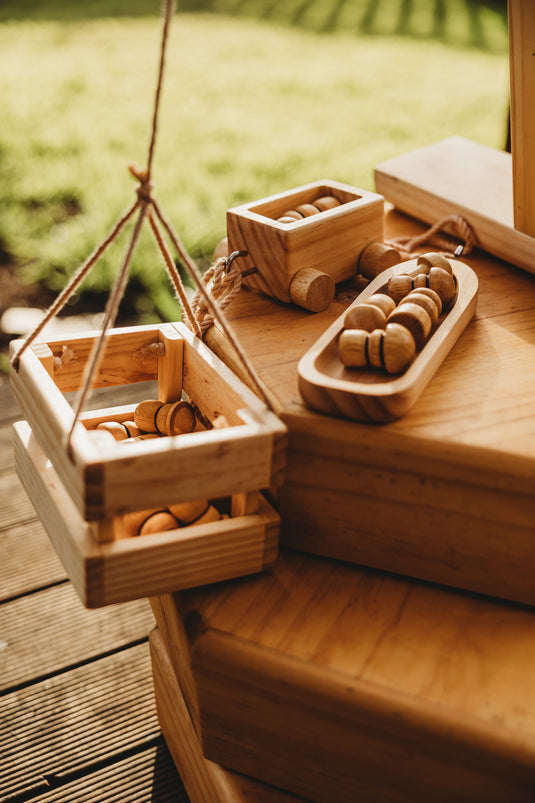 Wooden toys on a wooden surface with a blurred natural background